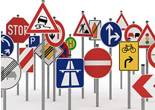 What is the difference between a road sign and a traffic sign